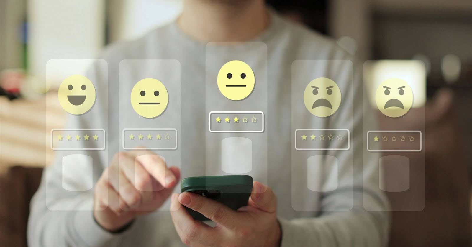Tシャツの男性がスマホをいじっている。スマホの上には、星5～星1評価の吹き出しが浮かんでいる。